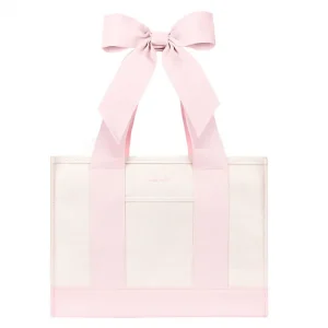 A light pink and white tote bag with wide pink shoulder straps and a large matching pink bow at the top, shown on a plain white background. #color_ballet pink bow