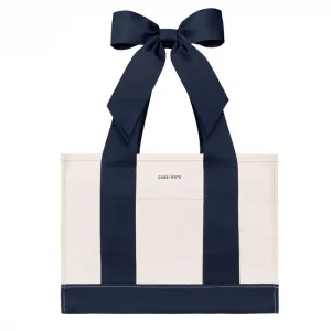 An off-white canvas tote bag with bold navy blue vertical stripes and matching navy ribbon handles tied in a large bow at the top. The brand name 'CASE-MATE' is printed in small black letters on the front pocket. #color_oxford navy bow
