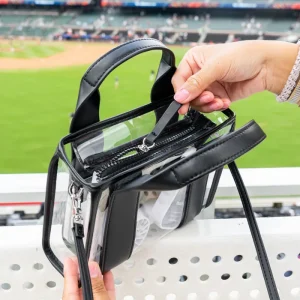 Person holding a clear sports bag with a stadium in the background #color_midnight_black