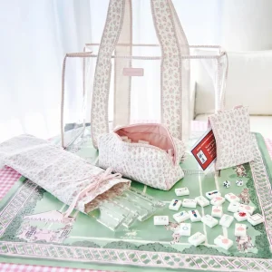 Set of white and pink bags with mohjong tiles and racks on a green mat #color_quilted ditsy floral