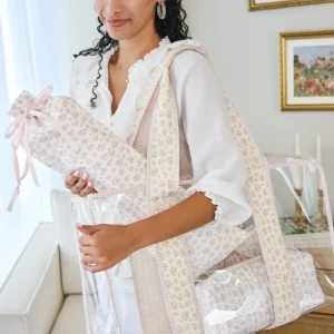 Woman holding a floral-patterned tote in a home setting #color_quilted ditsy floral