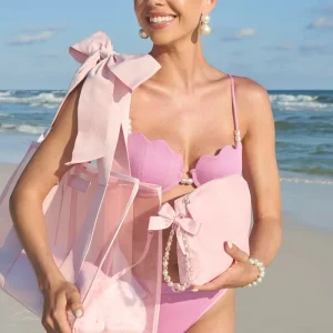 Woman in a pink bikini with a large bow on a beach #color_ballet pink bow
