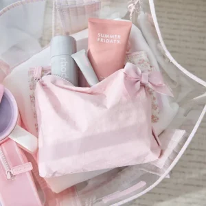 Pink skincare products including a bottle and tube with 'Summer Fridays' branding, placed on a white surface. #color_ballet pink bow